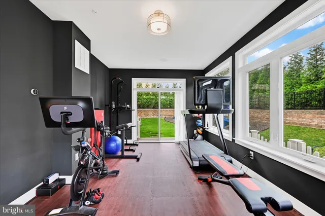 a view of a white house with a big yard and potted plants