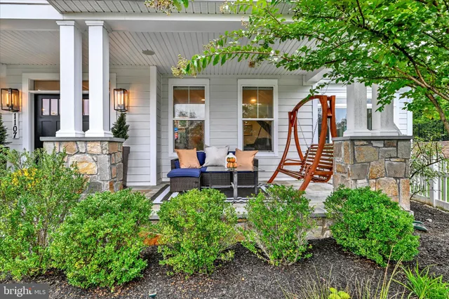 a outdoor space with the couches and dining table with the garden view