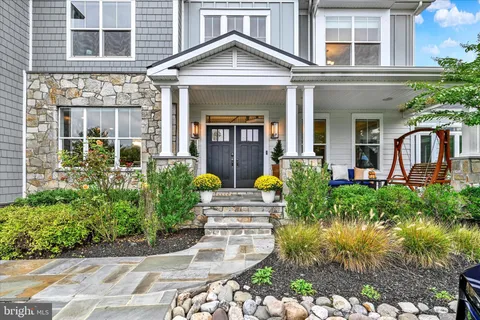 a outdoor space with the couches and dining table with the garden view