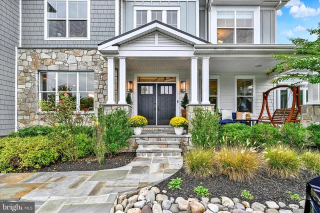 a outdoor space with the couches and dining table with the garden view