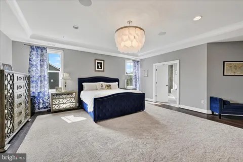 a living room with furniture a flat screen tv and a table