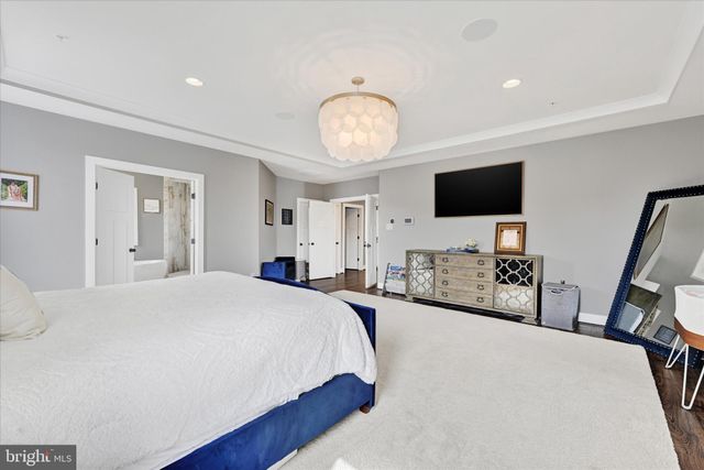 a room with a table chairs and a flat screen tv