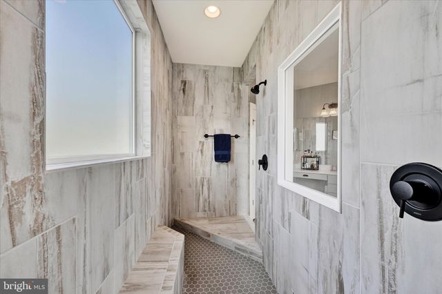 a living room with furniture pool table and wall painting