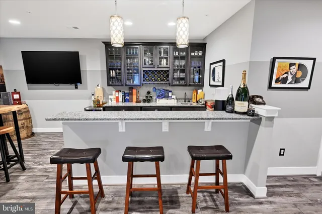 a view of a white house with a big yard and potted plants