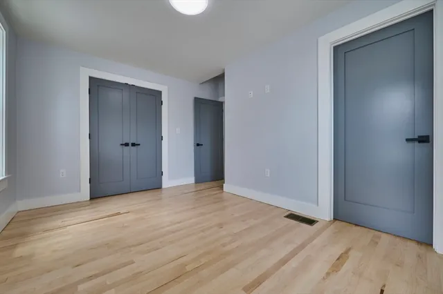a view of an empty room and wooden floor