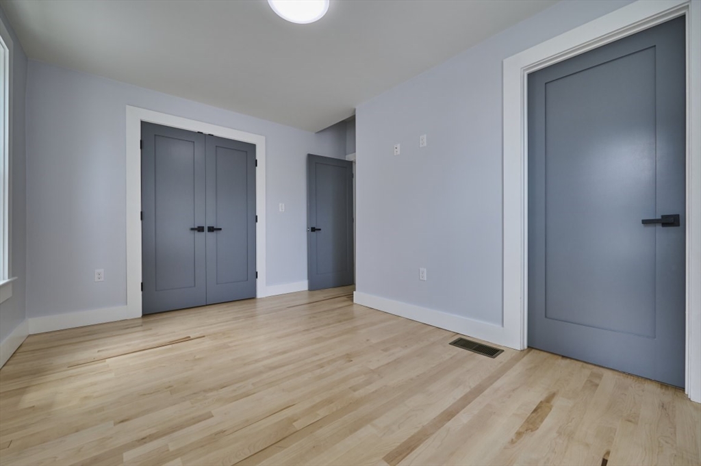 97 Oakton Avenue, Unit 1 Boston, MA 02122 - Photo 12 of 20 a view of an empty room and wooden floor