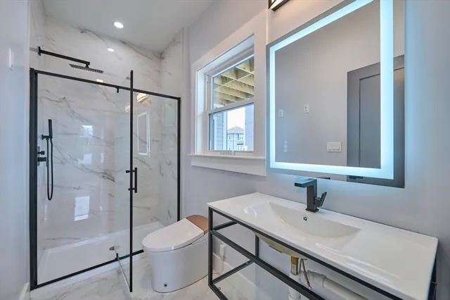 a bathroom with a sink toilet and shower