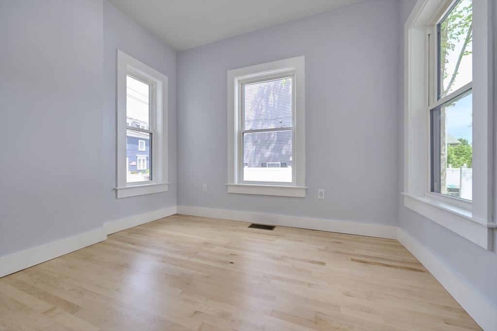 97 Oakton Avenue, Unit 1 Boston, MA 02122 - Photo 14 of 20 an empty room with windows