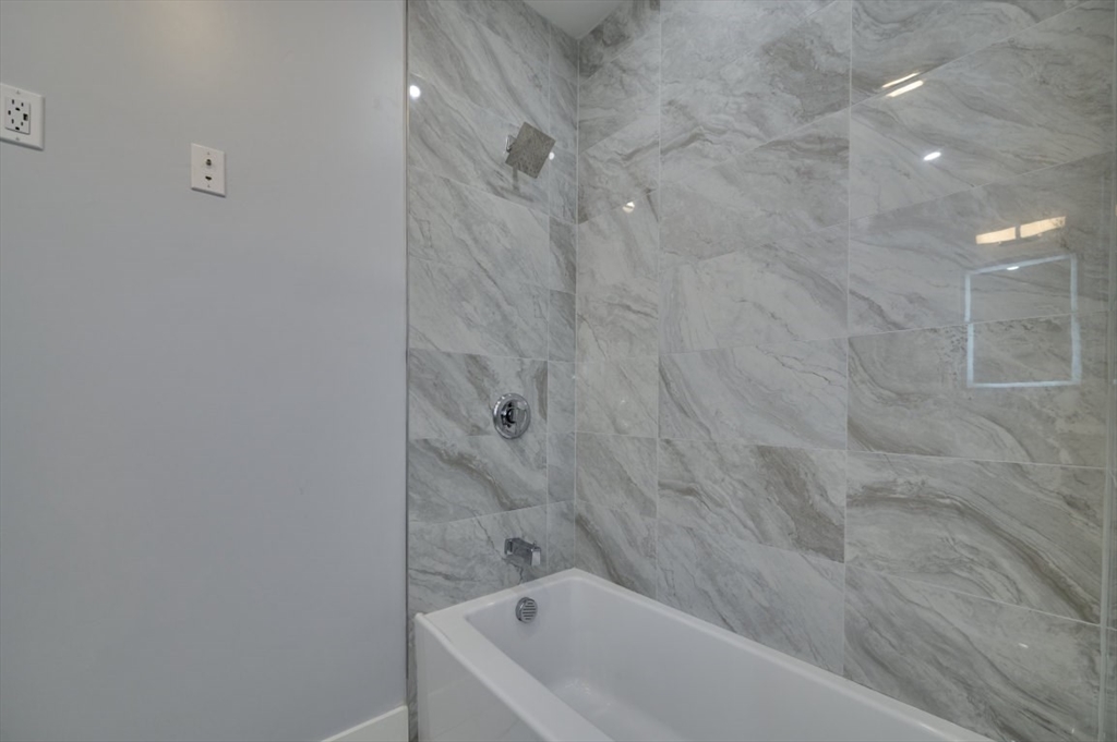 97 Oakton Avenue, Unit 1 Boston, MA 02122 - Photo 17 of 20 a bathroom with a bathtub