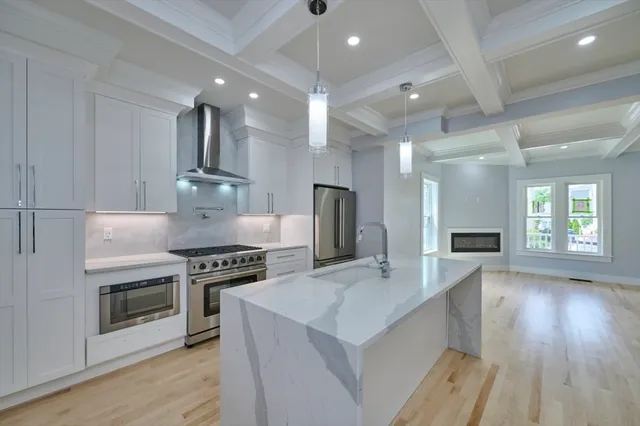 a kitchen with stove and wooden floor
