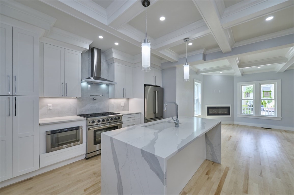 97 Oakton Avenue, Unit 1 Boston, MA 02122 - Photo 8 of 20 a kitchen with stove and wooden floor