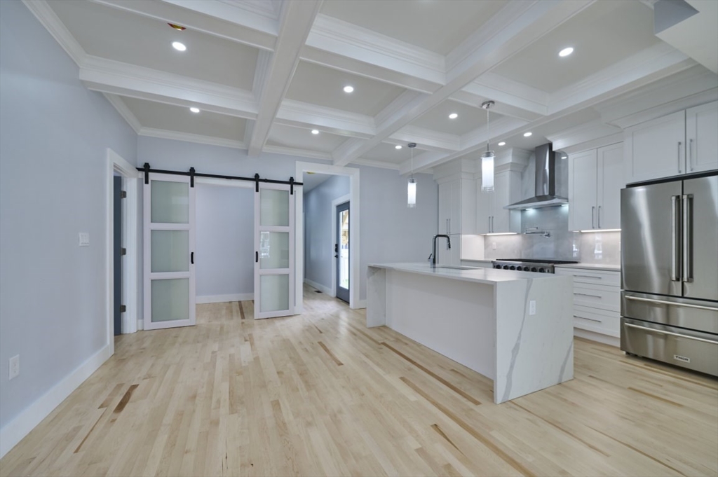 97 Oakton Avenue, Unit 1 Boston, MA 02122 - Photo 10 of 20 a large white kitchen with stainless steel appliances a refrigerator and a stove top oven