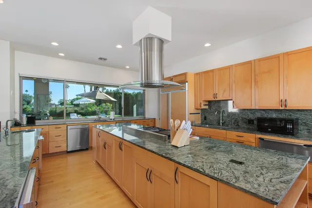 a living room with furniture and a painting on the wall