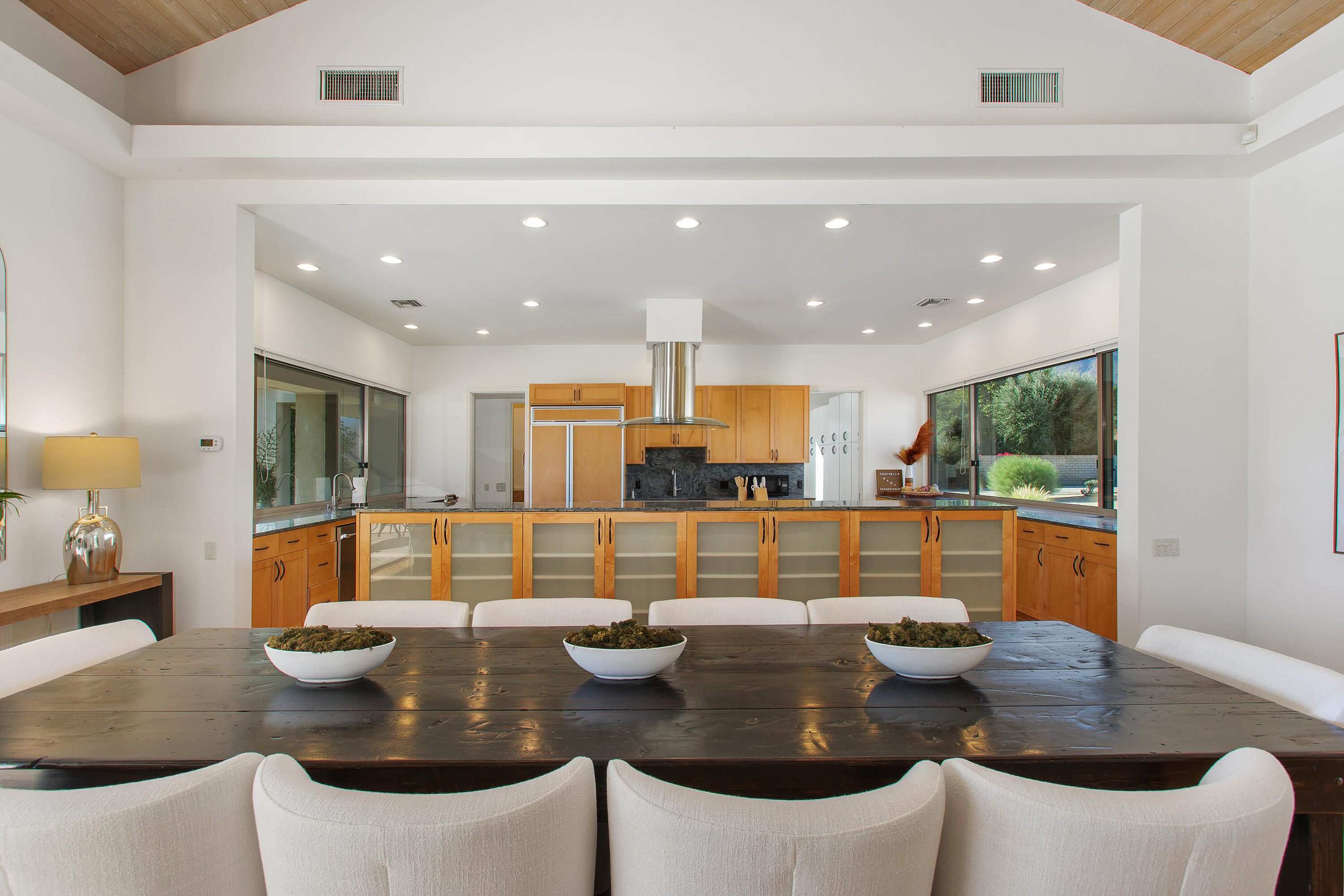 41750 Rancho Manana Lane Rancho Mirage, CA 92270 - Photo 8 of 37 a dining room with couches a large mirror and kitchen view