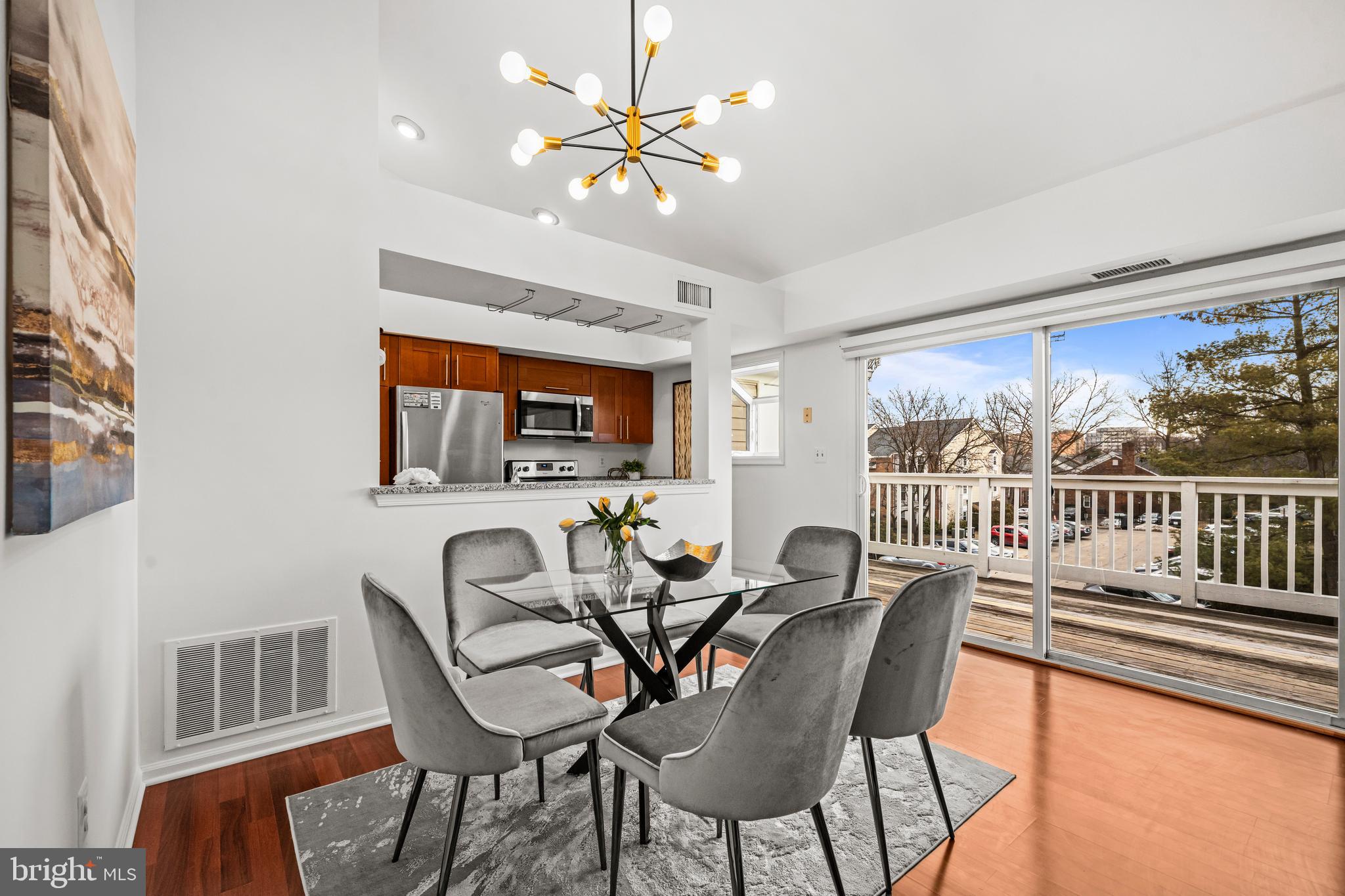 4531 28th Road South, Unit 97 Arlington, VA 22206 - Photo 5 of 32 a dining room with furniture a rug and a floor to ceiling window