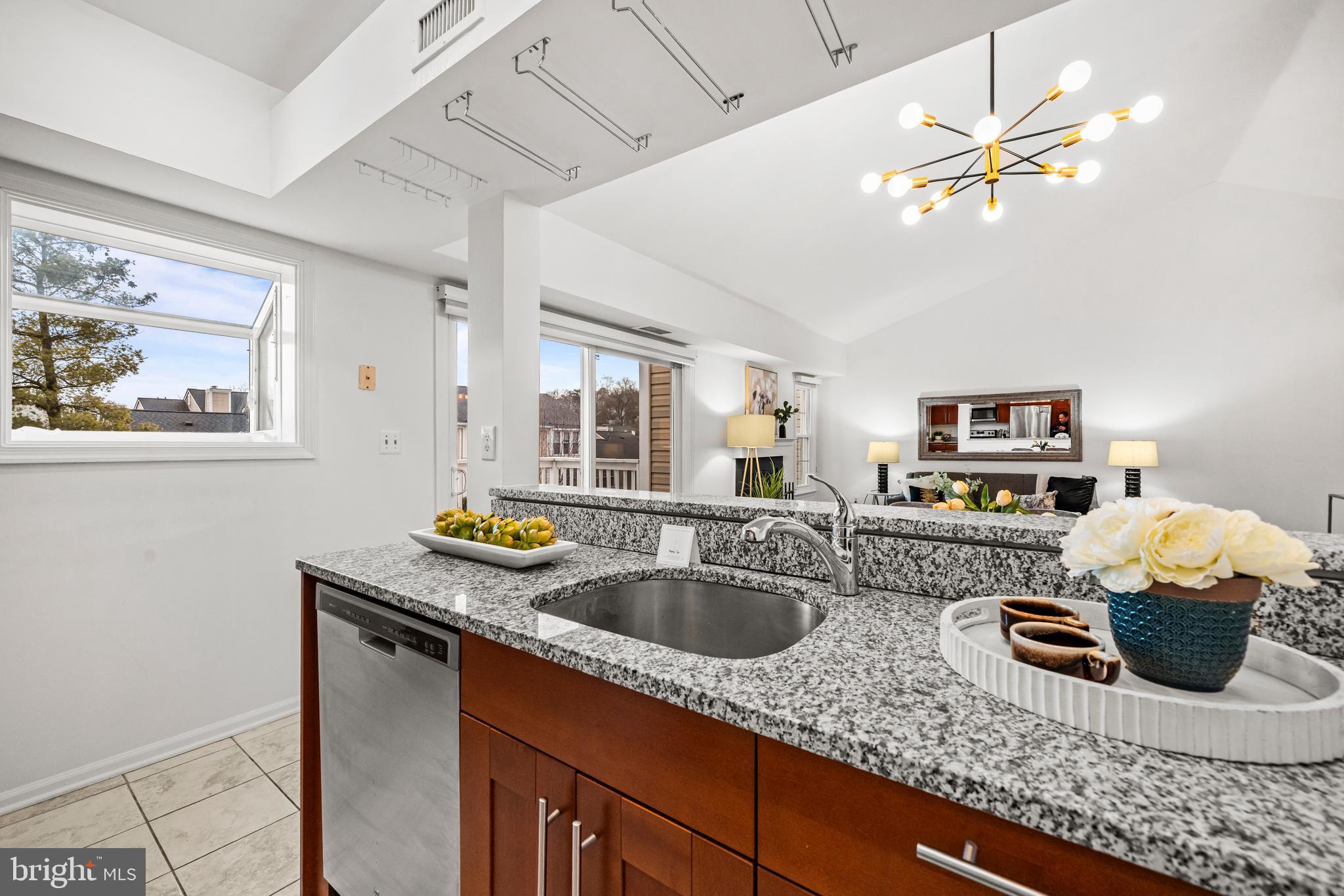 4531 28th Road South, Unit 97 Arlington, VA 22206 - Photo 9 of 32 a kitchen with stainless steel appliances granite countertop a sink a stove and a wooden cabinets