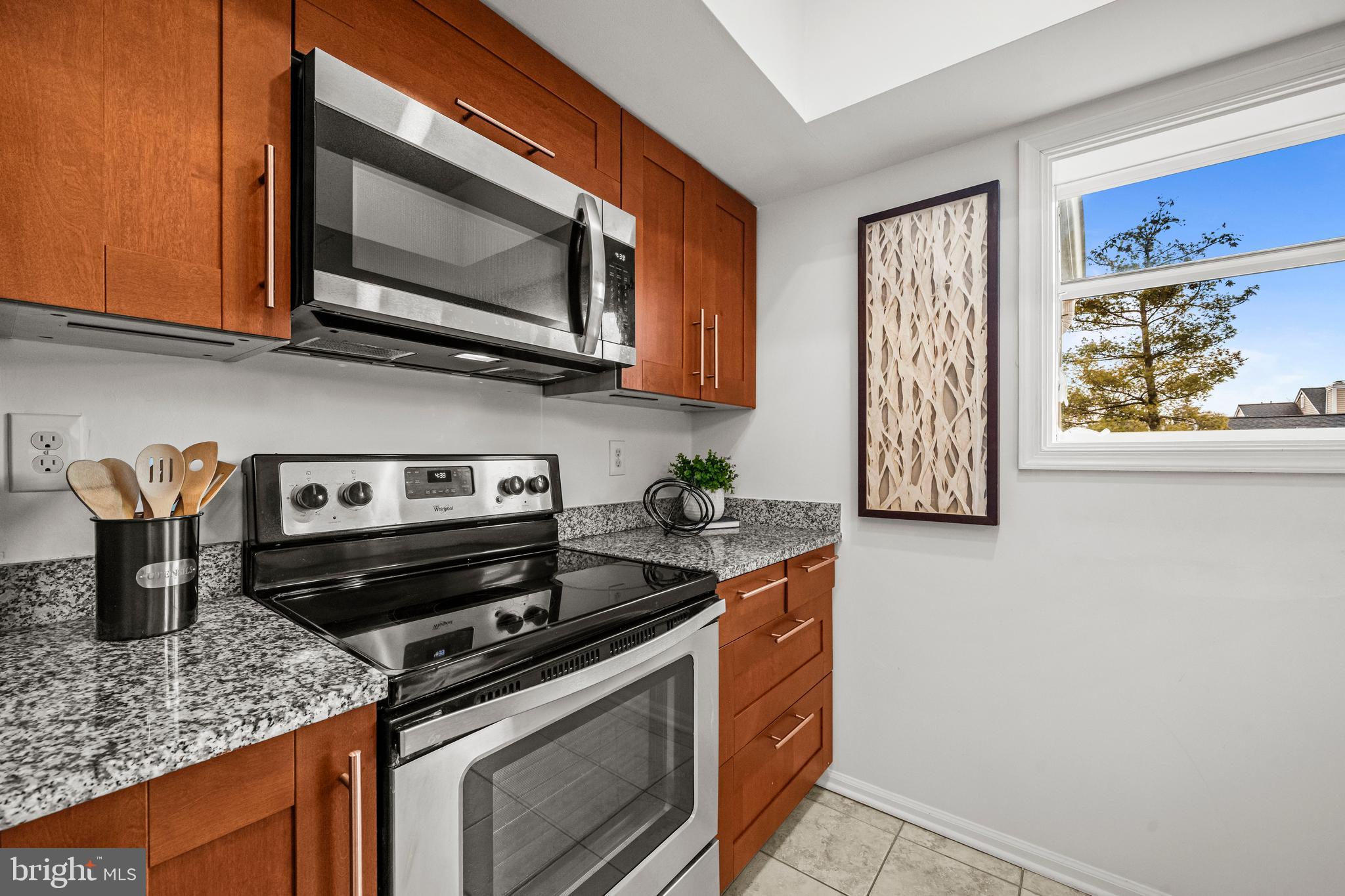 4531 28th Road South, Unit 97 Arlington, VA 22206 - Photo 10 of 32 a kitchen with stainless steel appliances granite countertop a stove microwave and sink