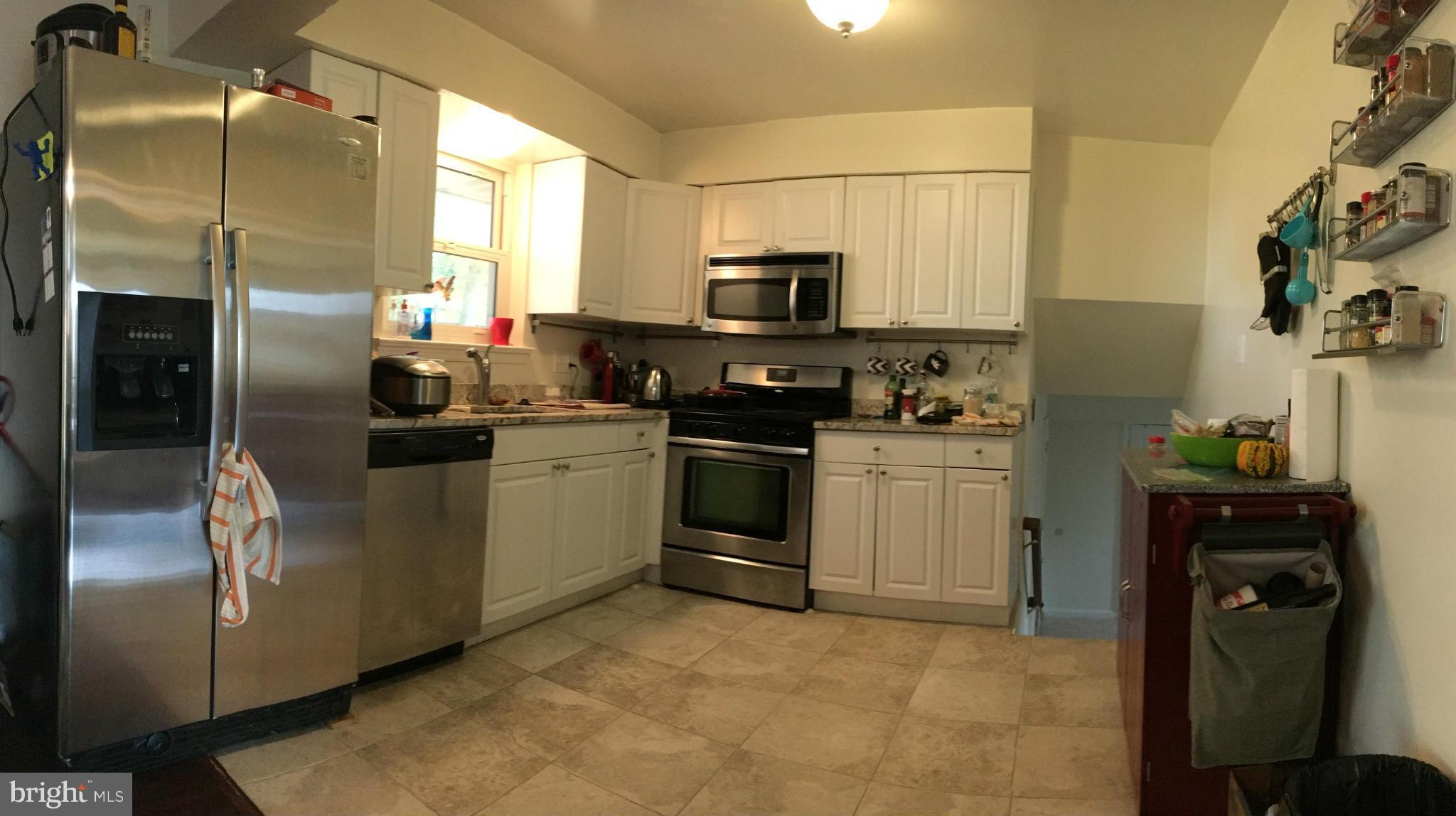 5319 Ravensworth Road Springfield, VA 22151 - Photo 3 of 14 a kitchen with stainless steel appliances a refrigerator sink and microwave
