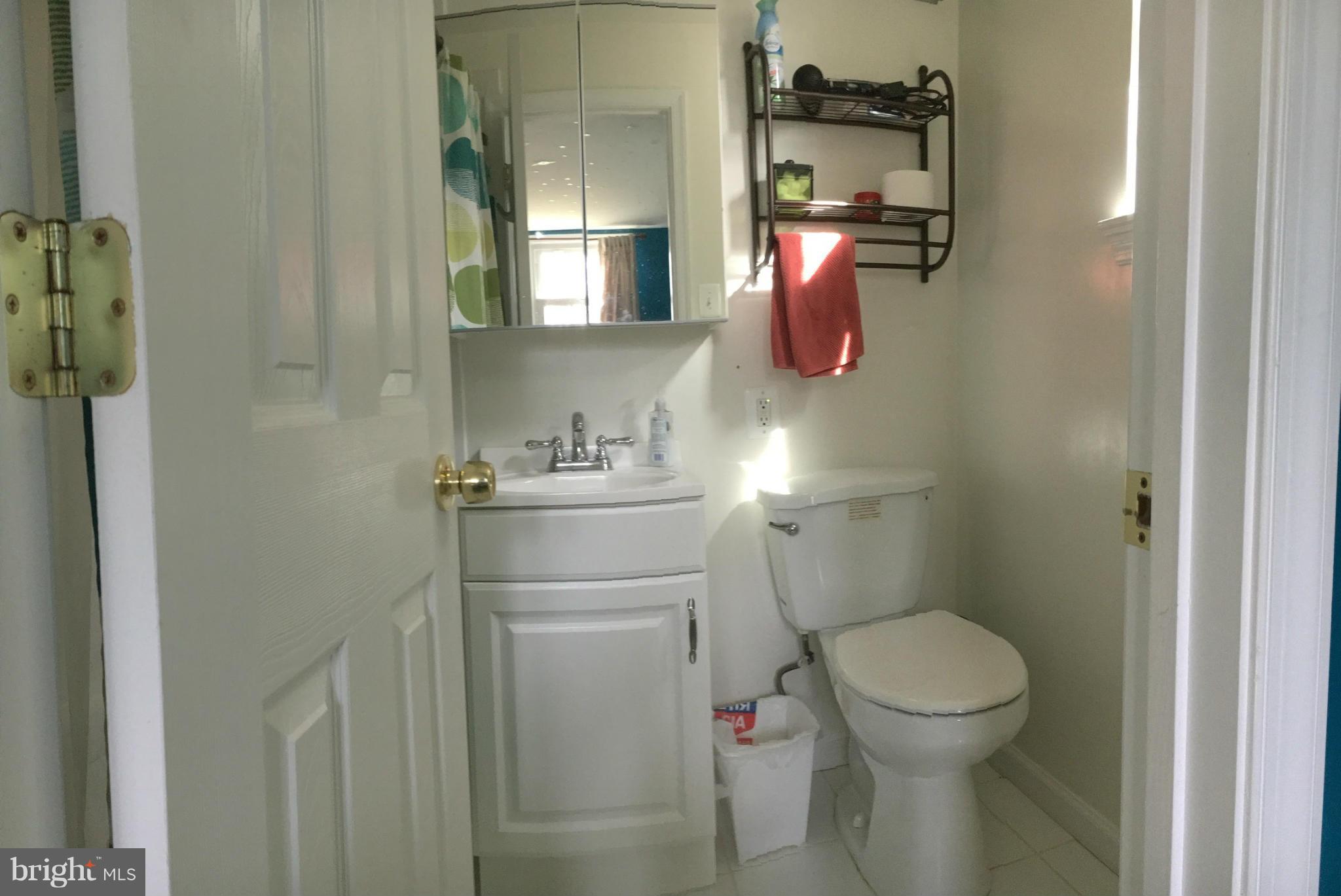 5319 Ravensworth Road Springfield, VA 22151 - Photo 6 of 14 a bathroom with a toilet sink and mirror