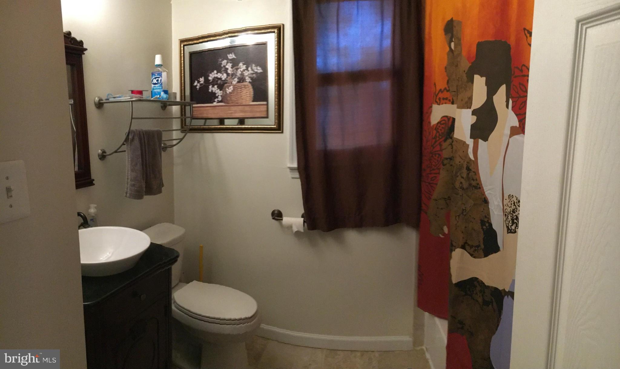 5319 Ravensworth Road Springfield, VA 22151 - Photo 10 of 14 a bathroom with a toilet and a shower curtain