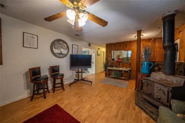 a living room with furniture a flat screen tv and kitchen view