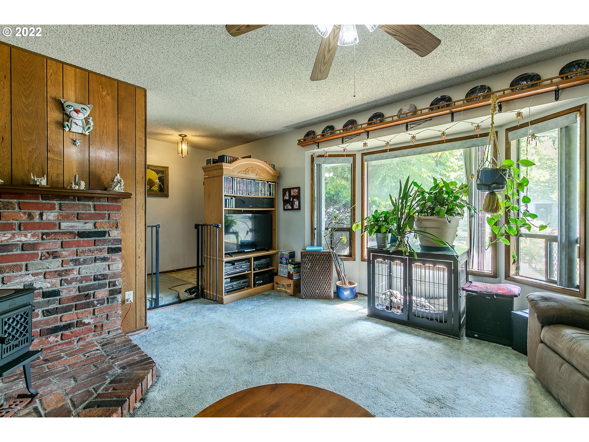 906 62nd Street Springfield, OR 97478 - Photo 8 of 14 a living room with furniture a flat screen tv and floor to ceiling window