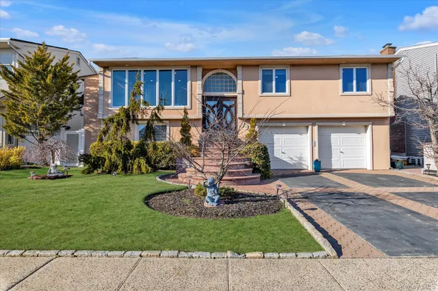 a front view of a house with garden