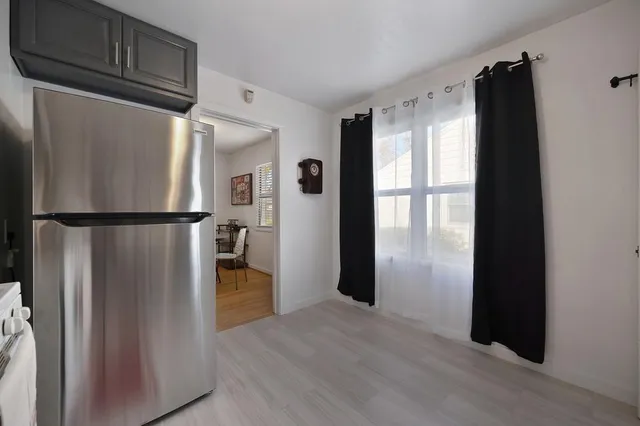 a kitchen with stainless steel appliances granite countertop a refrigerator and a refrigerator