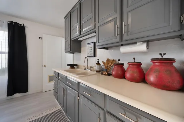 a kitchen with stainless steel appliances granite countertop a sink dishwasher stove and cabinets