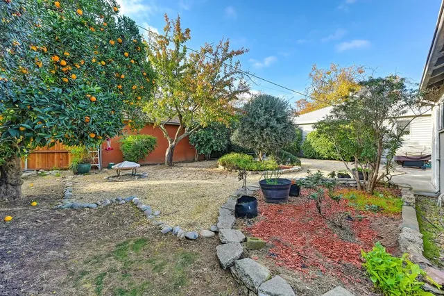 a view of backyard with a table and chairs