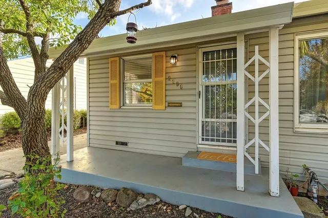 a view of a house with a tree