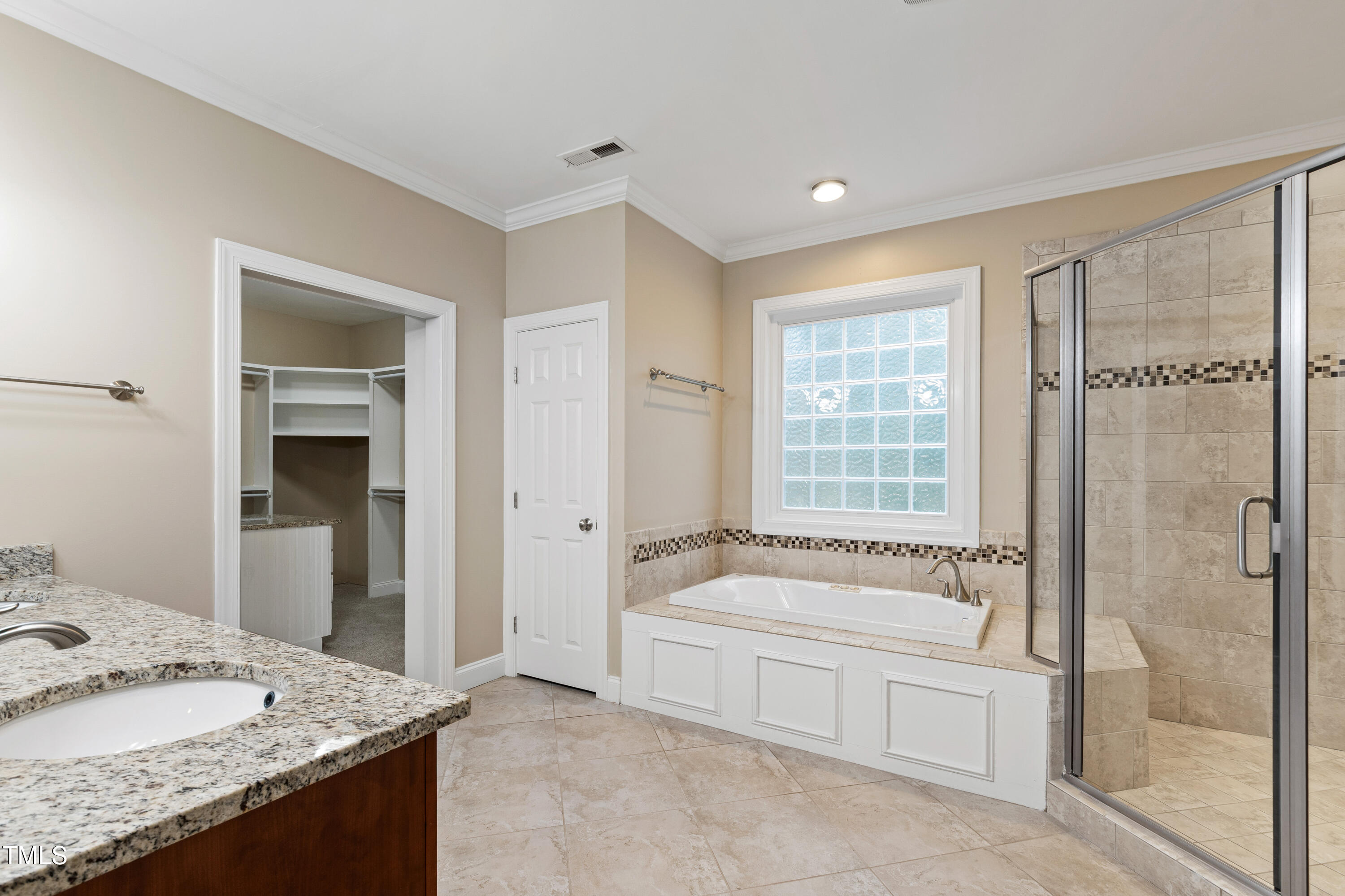 4517 Gates Street Raleigh, NC 27609 - Photo 28 of 66 a spacious bathroom with a granite countertop tub sink and mirror