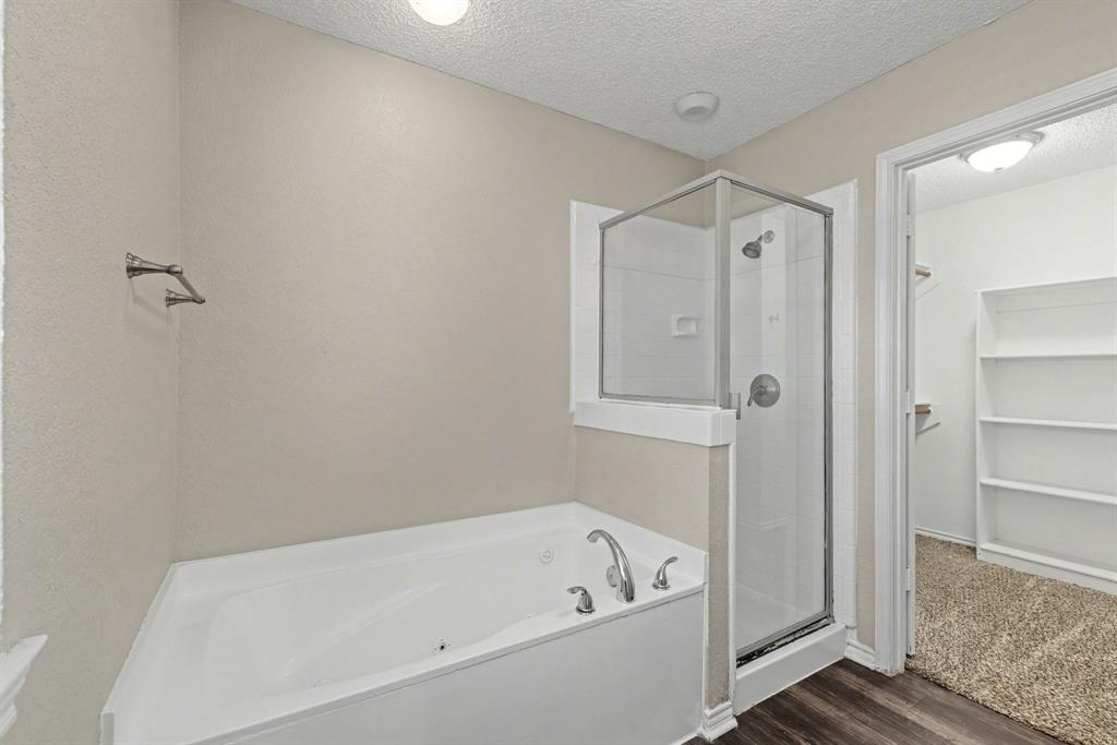 124 Summit Cove Trophy Club, TX 76262 - Photo 14 of 23 a white bath tub sitting next to a shower