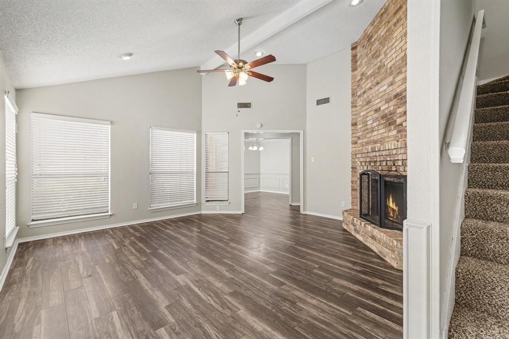 124 Summit Cove Trophy Club, TX 76262 - Photo 4 of 23 a view of an empty room with wooden floor fireplace and a window