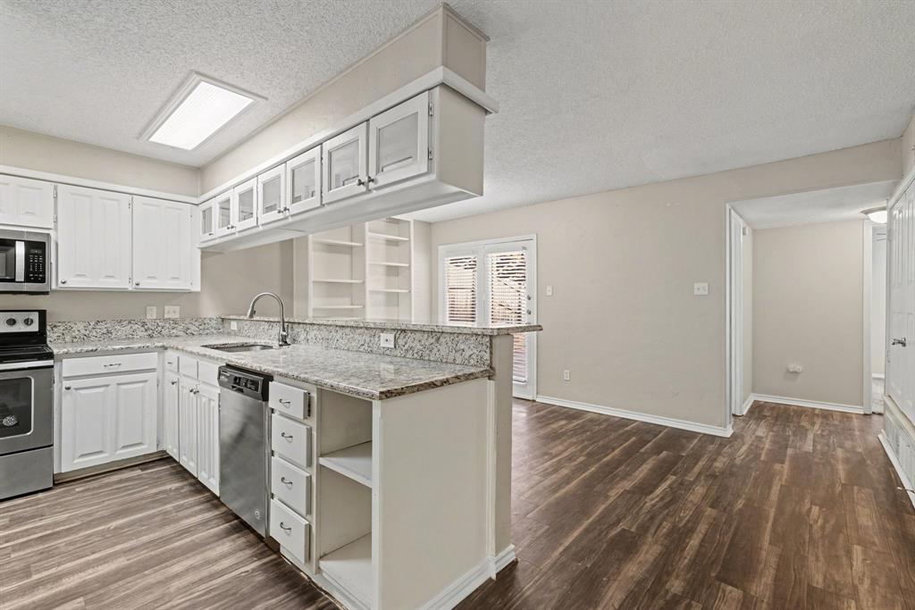 124 Summit Cove Trophy Club, TX 76262 - Photo 7 of 23 a kitchen with a sink stove and cabinets