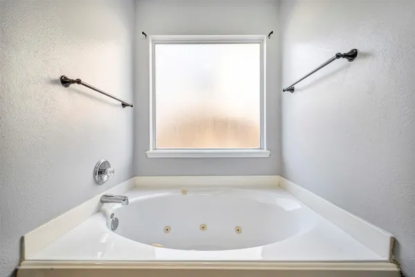 a white bath tub sitting in a bathroom