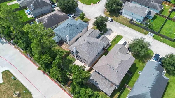 an aerial view of a house with a yard