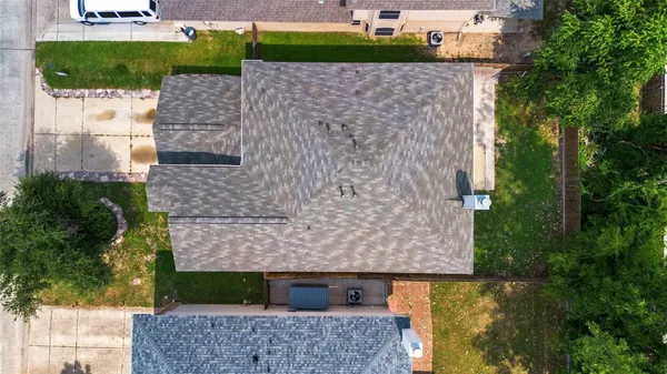 an aerial view of a house with a yard