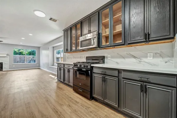 a kitchen with stainless steel appliances granite countertop a stove and a sink