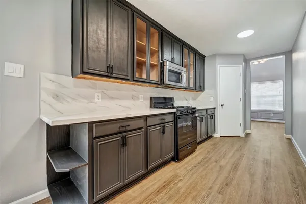 a kitchen with stainless steel appliances granite countertop a stove and a sink