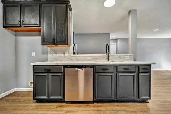 a kitchen with stainless steel appliances granite countertop a sink and cabinets