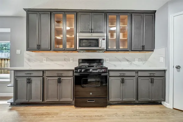 a kitchen with stainless steel appliances granite countertop a stove and a sink