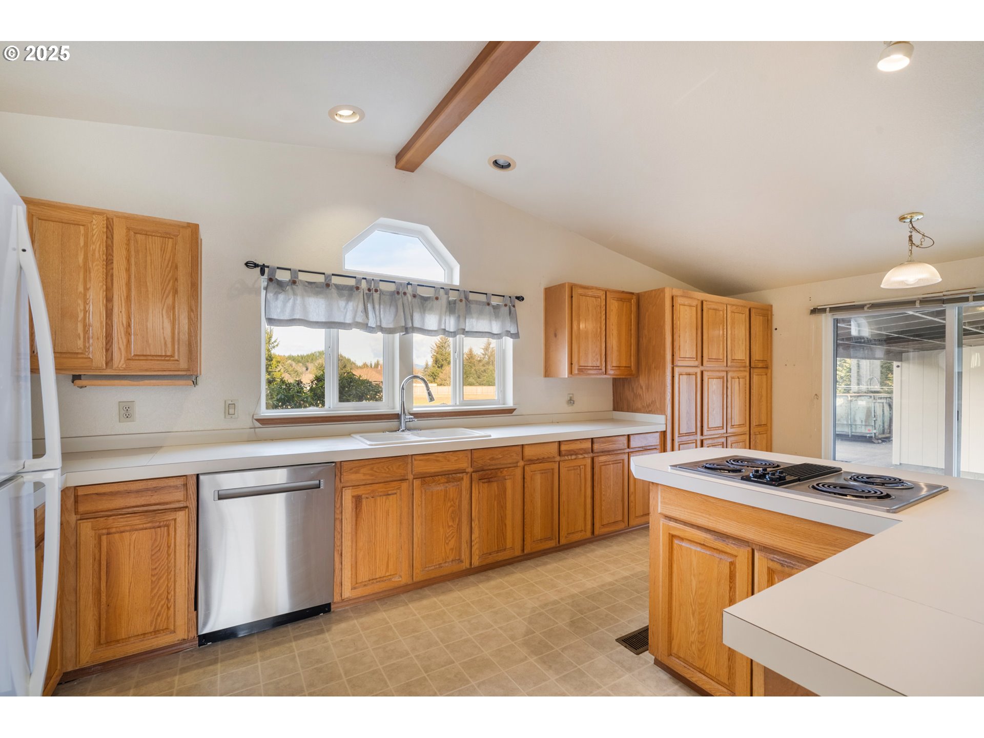 9776 South Prairie Road Tillamook, OR 97141 - Photo 12 of 38 a kitchen with stainless steel appliances granite countertop a stove a sink and a refrigerator