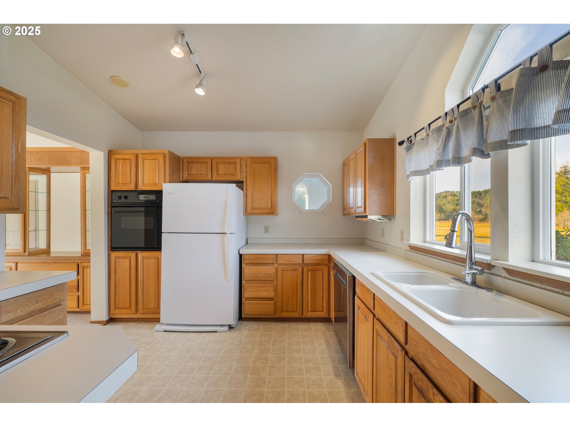 9776 South Prairie Road Tillamook, OR 97141 - Photo 13 of 38 a kitchen with a sink refrigerator and microwave