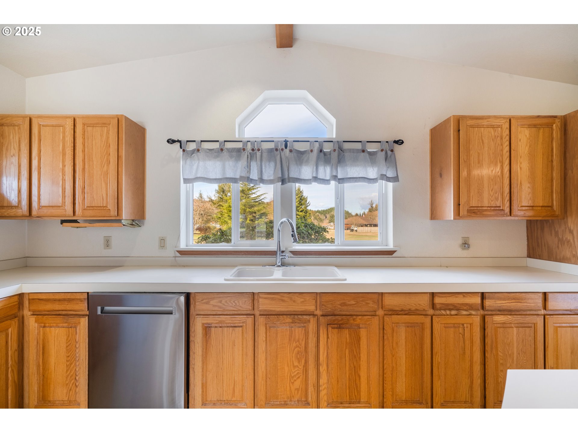 9776 South Prairie Road Tillamook, OR 97141 - Photo 16 of 38 a kitchen with a sink a window and cabinets