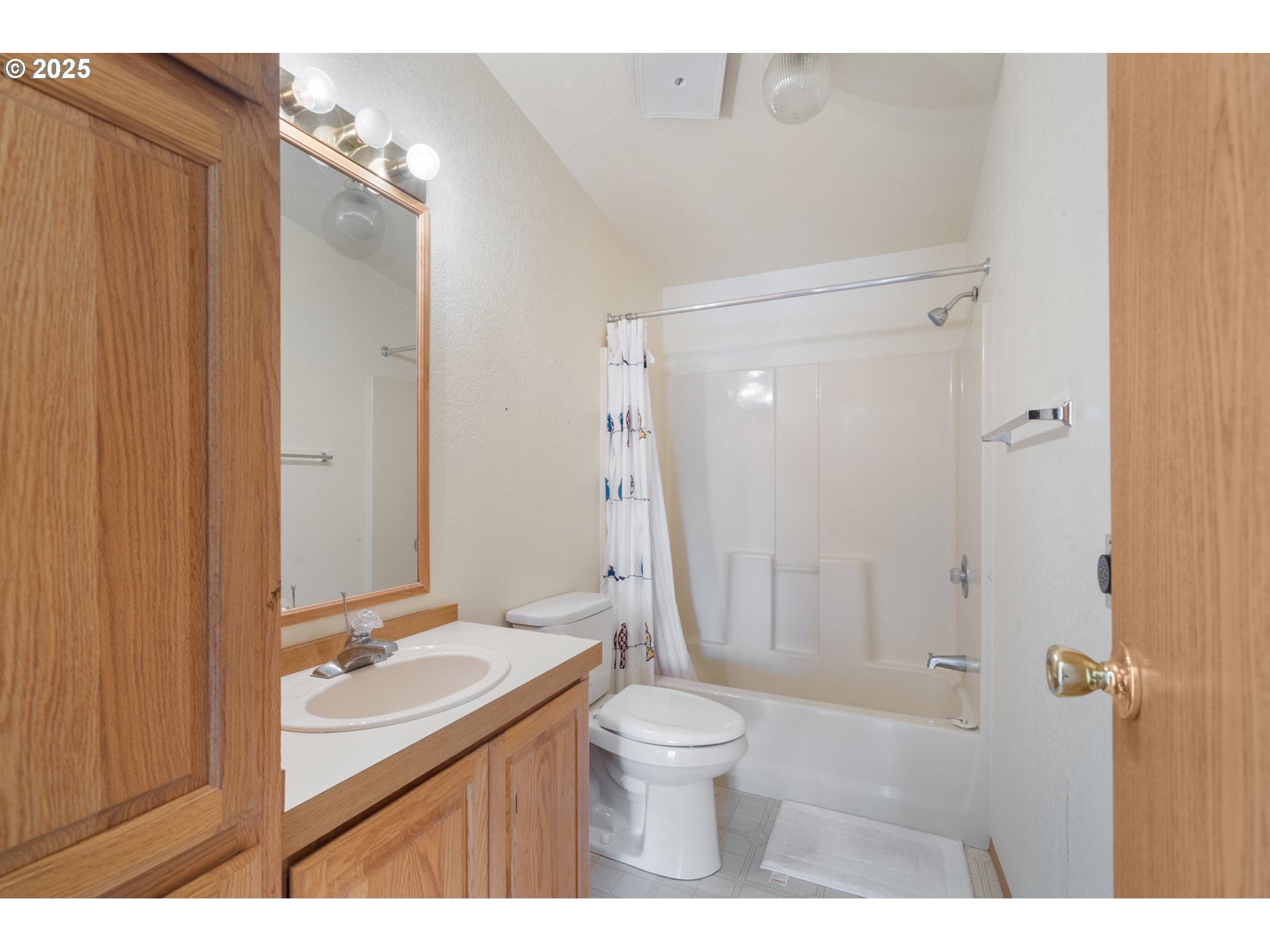 9776 South Prairie Road Tillamook, OR 97141 - Photo 18 of 38 a bathroom with a granite countertop sink toilet a mirror and shower