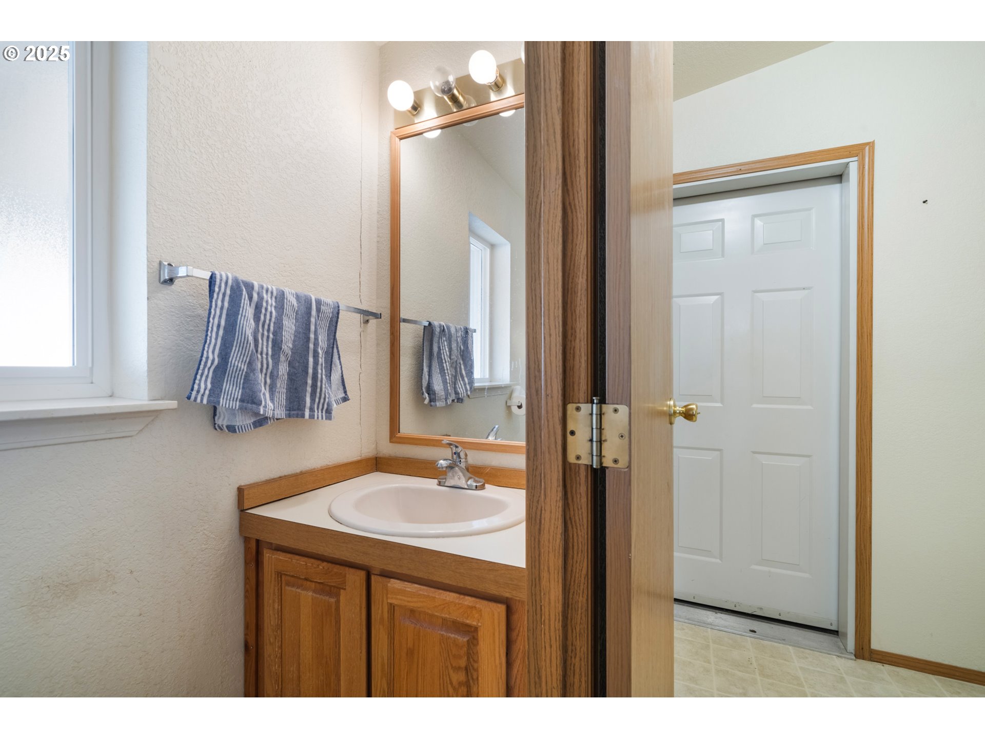 9776 South Prairie Road Tillamook, OR 97141 - Photo 19 of 38 a bathroom with a sink vanity and mirror