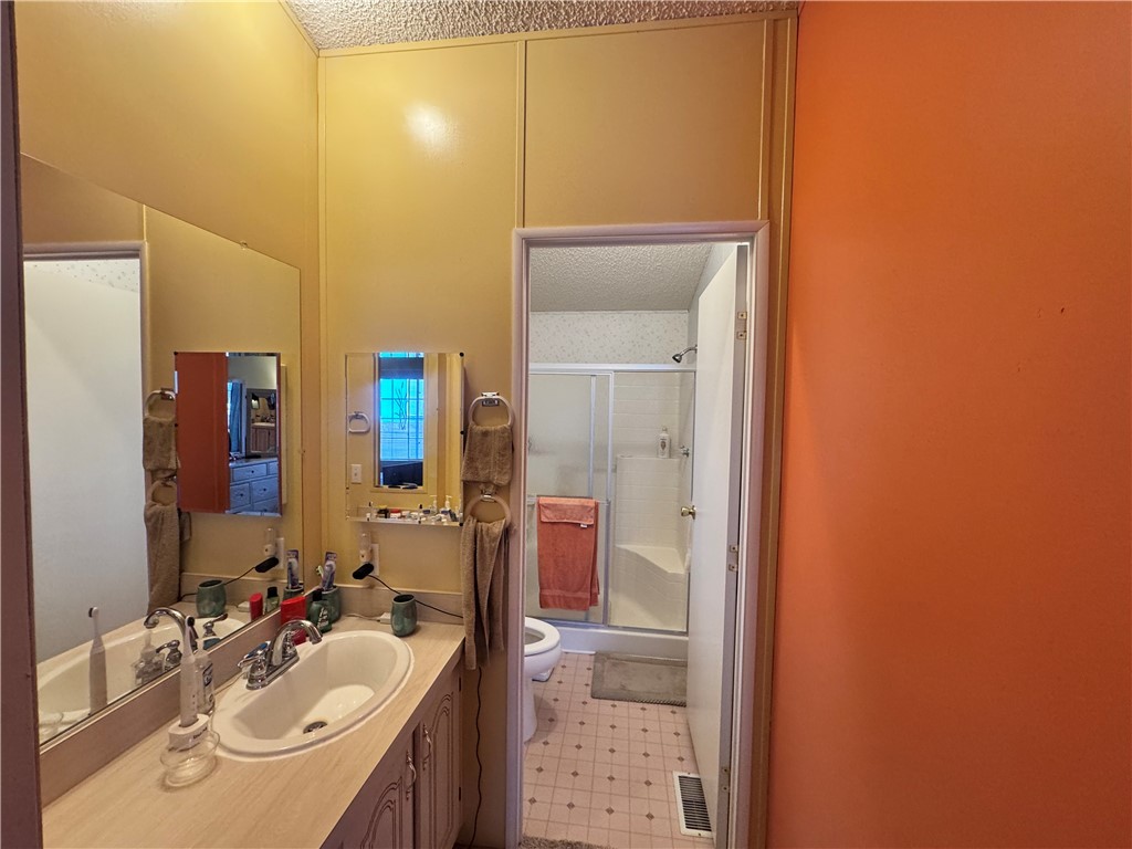 2532 Morgan Road Fort Mohave, AZ 86426 - Photo 19 of 29 Full bathroom with a stall shower, vanity, light flooring, and a textured ceiling