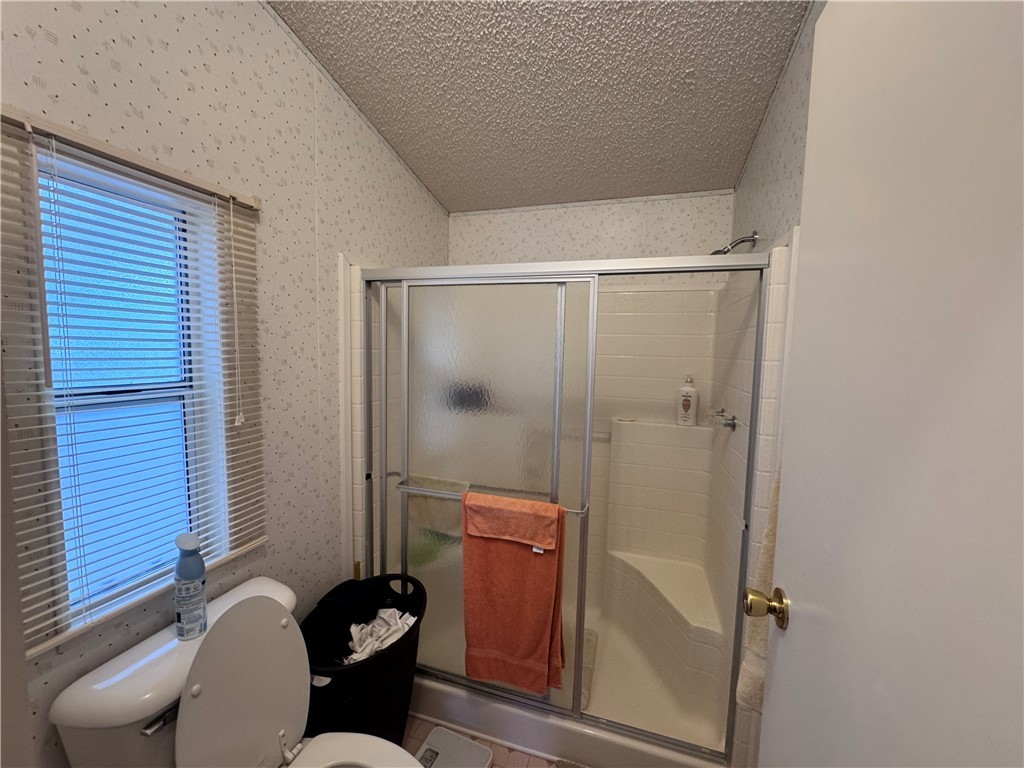2532 Morgan Road Fort Mohave, AZ 86426 - Photo 20 of 29 Full bath with wallpapered walls, a stall shower, a textured ceiling, and tile patterned floors