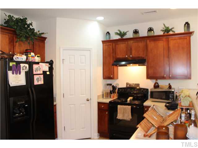 2545 Spring Oaks Way Raleigh, NC 27614 - Photo 2 of 12 Kitchen with black appliances, maple cabinets and pantry